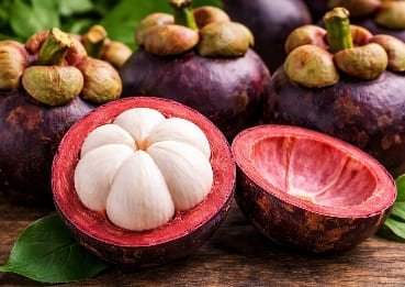 Fresh mangosteen fruit, whole and cut open